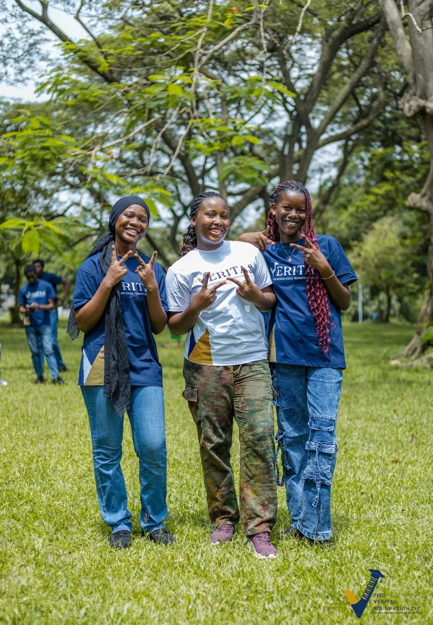 Three Veritas scholars smiling at the Day 1 photoshoot