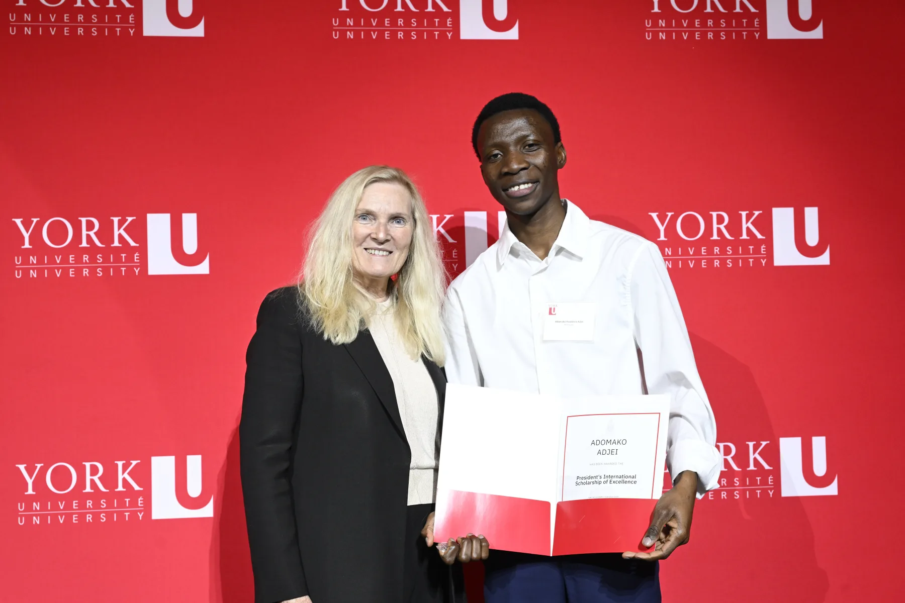 A Veritas scholar holding an award at York University